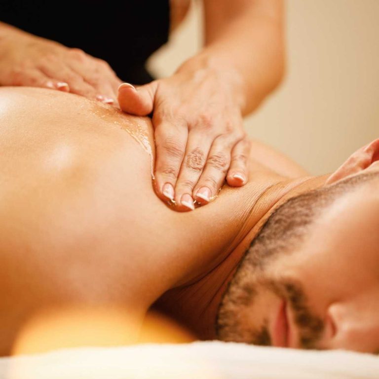 closeup-man-enjoying-relaxing-back-massage-with-honey-spa