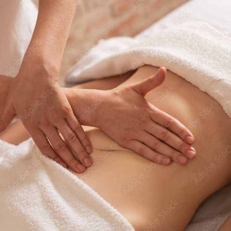 relaxing massage and body shaping massage, lymphatic drainage, manual and aesthetic procedures, hands massaging belly in the spa